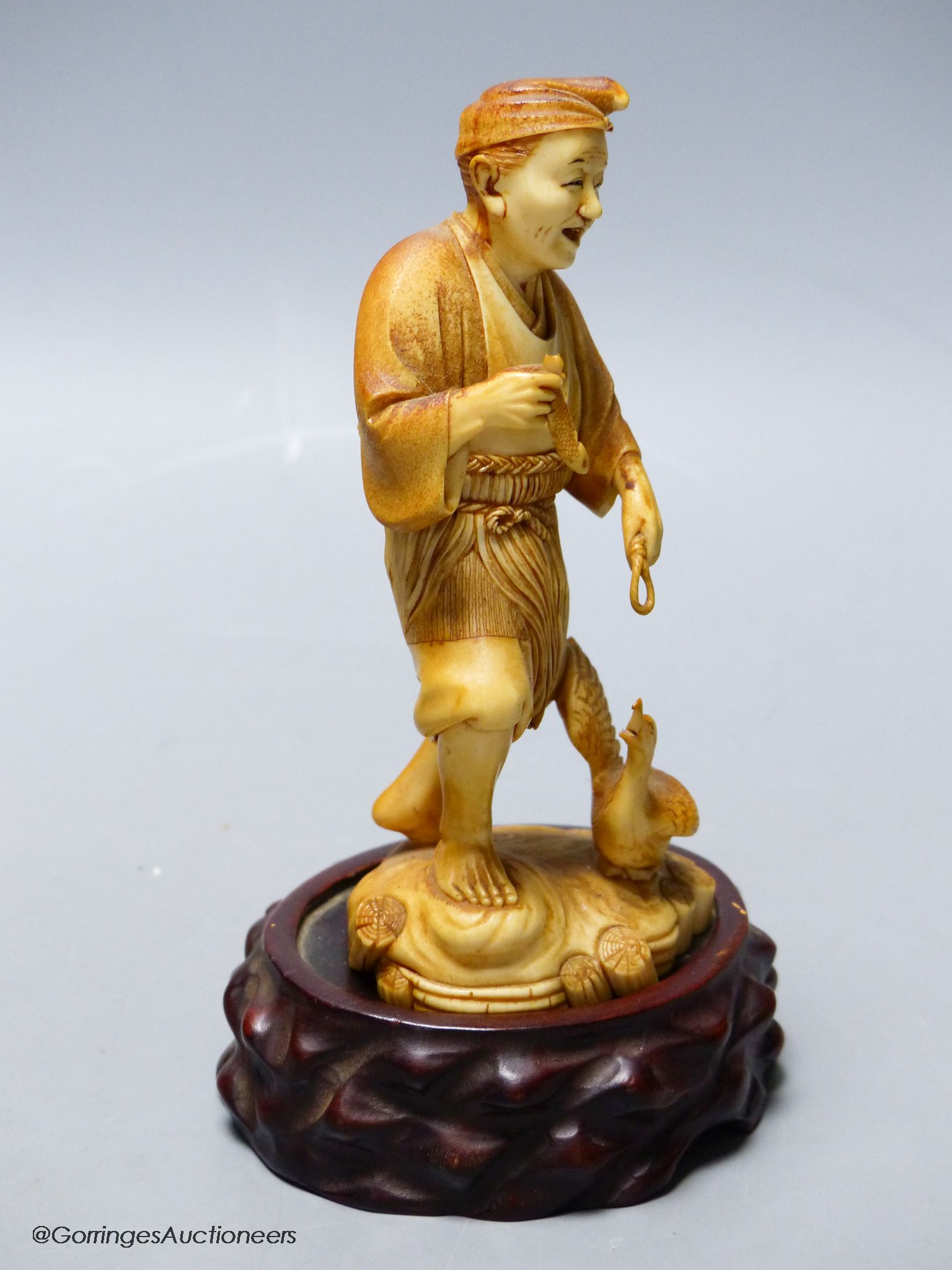 A Japanese ivory figure of a cormorant fisherman, early 20th century